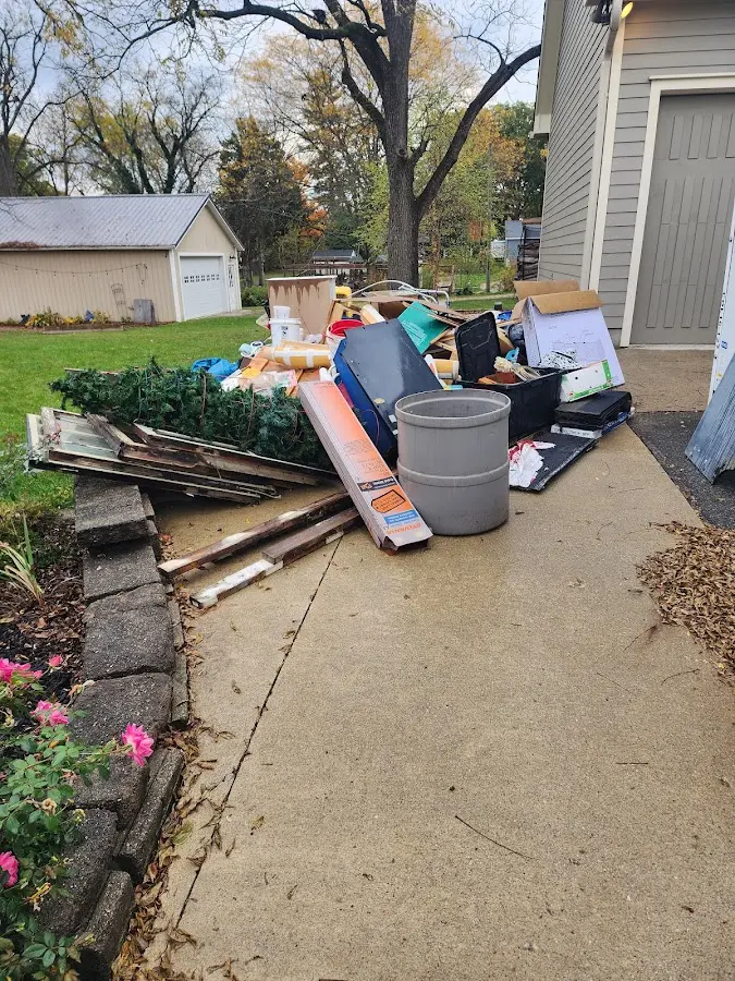 Dumpster being loaded with debris for Residential Dumpster Rental in Littleton